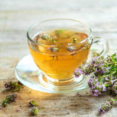 Thyme tea in a cup. Selective focus.